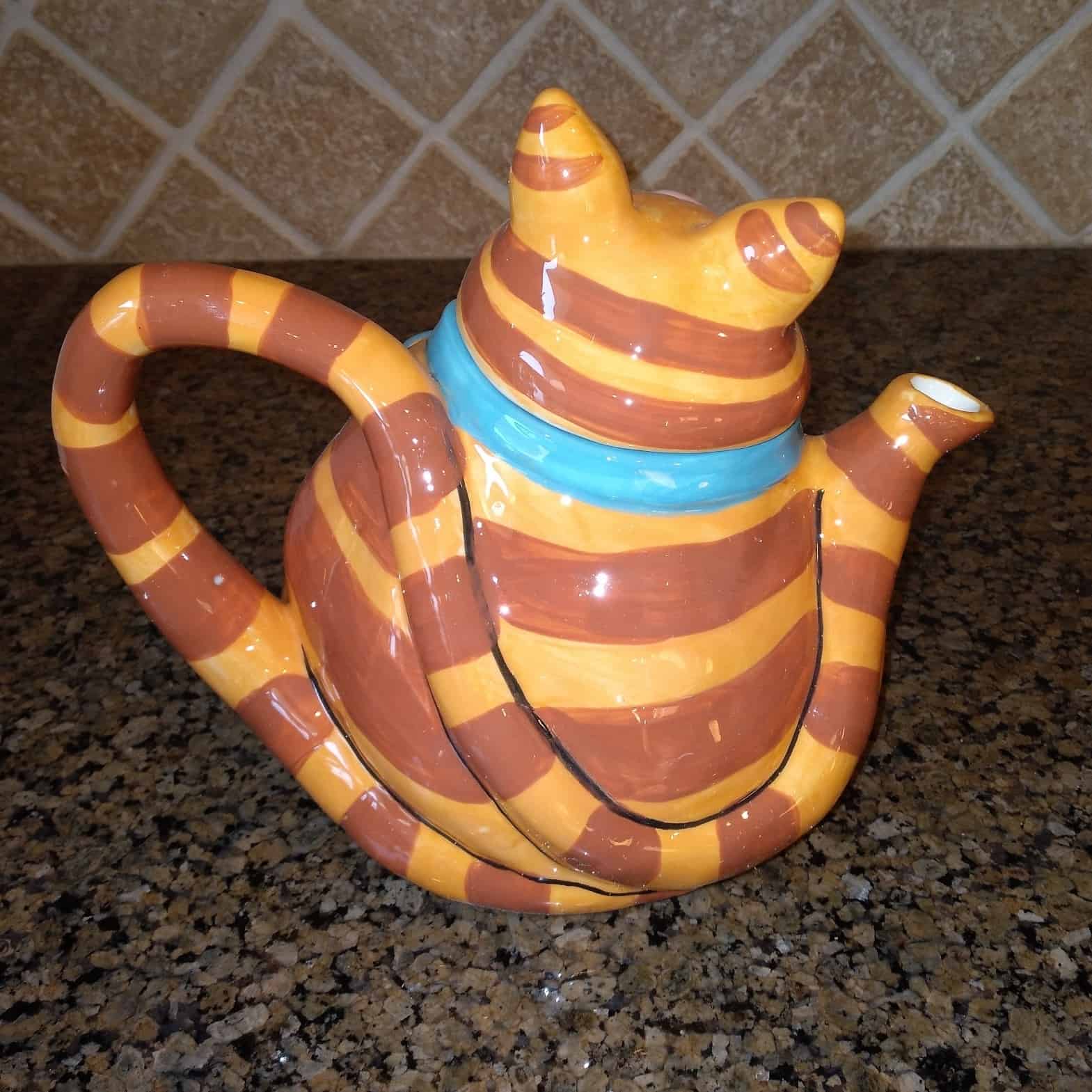 This Orange Cat Ceramic Teapot Decorative Kitchen Decor Blue Sky by Lynda Corneille is made with love by Premier Homegoods! Shop more unique gift ideas today with Spots Initiatives, the best way to support creators.