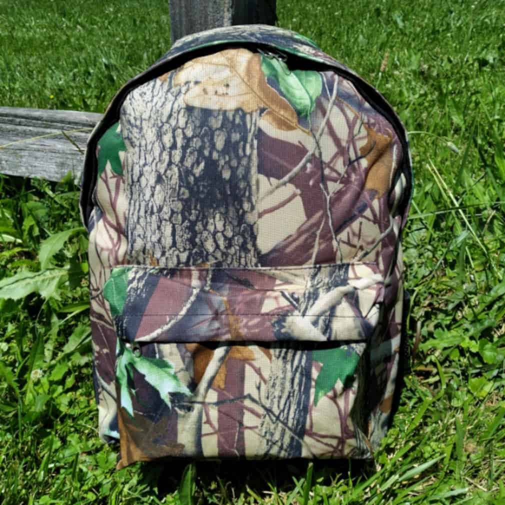 This Multipurpose Backpack Natural Camo with Black Trim and Padded Straps 16" (41cm) is made with love by Premier Homegoods! Shop more unique gift ideas today with Spots Initiatives, the best way to support creators.