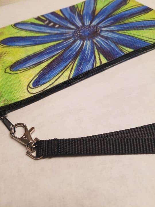This Wristlet "Blue Daisy" is made with love by Studio Patty D! Shop more unique gift ideas today with Spots Initiatives, the best way to support creators.