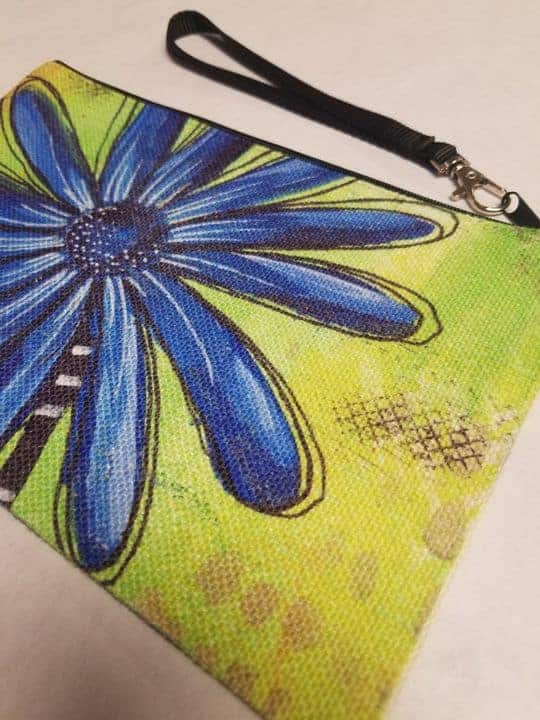 This Wristlet "Blue Daisy" is made with love by Studio Patty D! Shop more unique gift ideas today with Spots Initiatives, the best way to support creators.