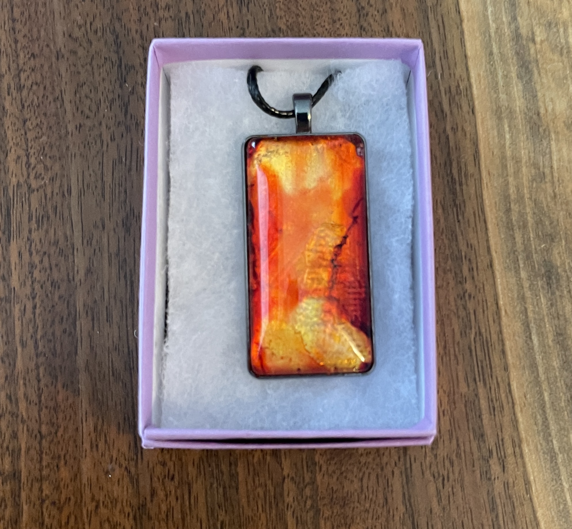 This Pendant Necklace Orange and Gold hand painted rectangular is made with love by Designs by Starla! Shop more unique gift ideas today with Spots Initiatives, the best way to support creators.