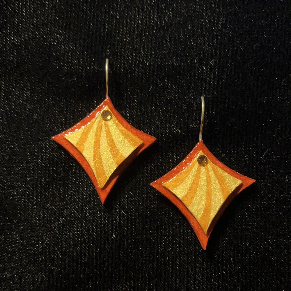 This Curvy Square Jewelry Art Earrings In Orange And Gold With Swarovski Crystals is made with love by Premier Homegoods! Shop more unique gift ideas today with Spots Initiatives, the best way to support creators.