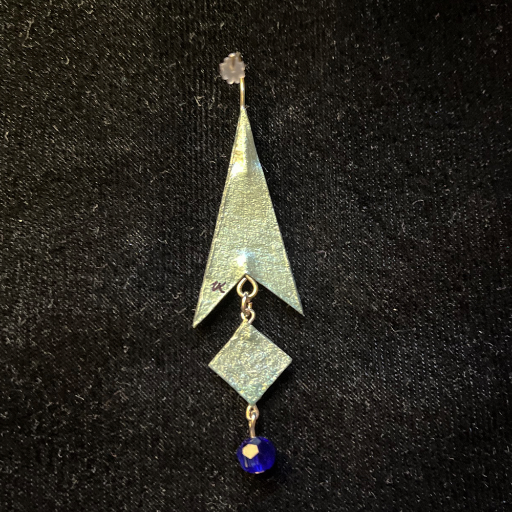 This Arrow Shaped Jewelry Art Earrings With Diamond Shaped Dangle Blue and Silver is made with love by Premier Homegoods! Shop more unique gift ideas today with Spots Initiatives, the best way to support creators.