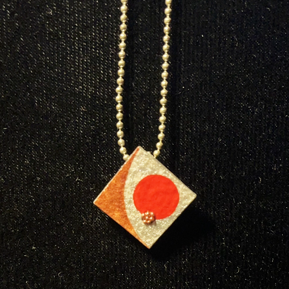 This Diamond Pendant Jewelry Art In Silver, Red And Metallic Red With Red Micro Beads is made with love by Premier Homegoods! Shop more unique gift ideas today with Spots Initiatives, the best way to support creators.
