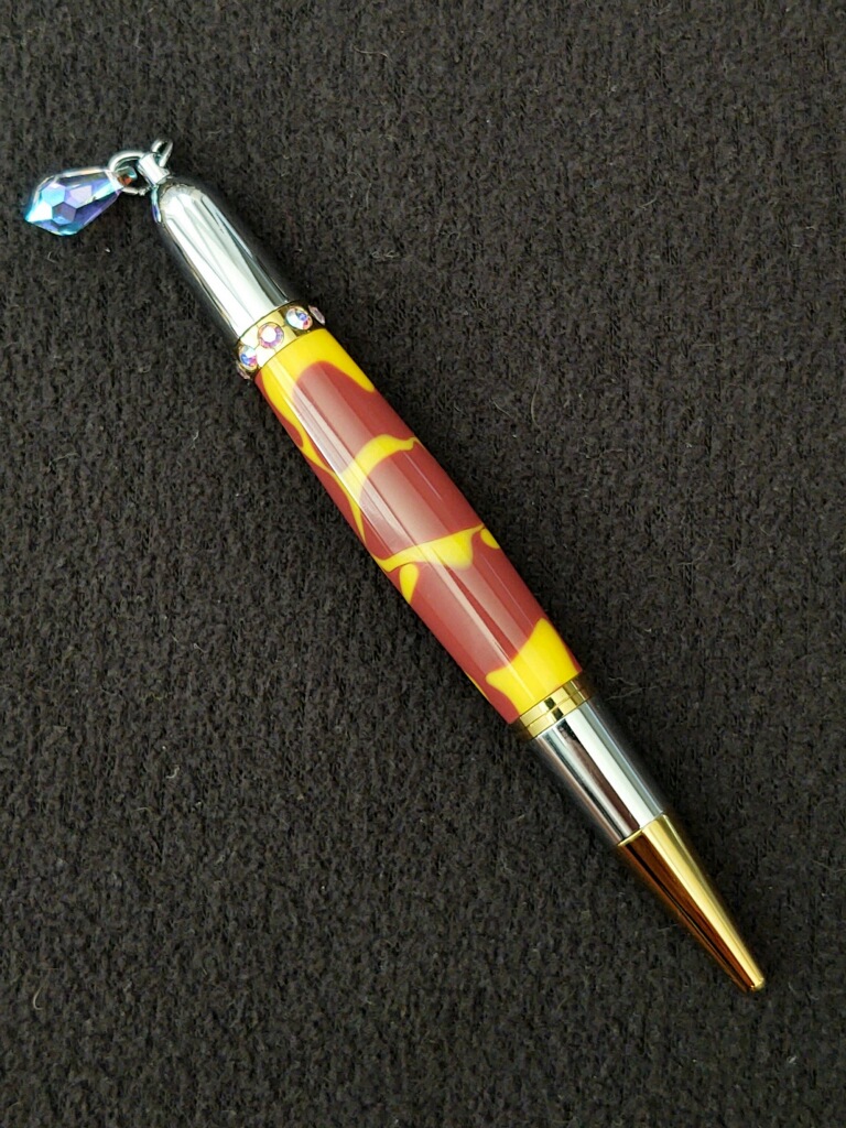 This Red & Yellow Diva Charm Pen is made with love by Blackbear Designs! Shop more unique gift ideas today with Spots Initiatives, the best way to support creators.