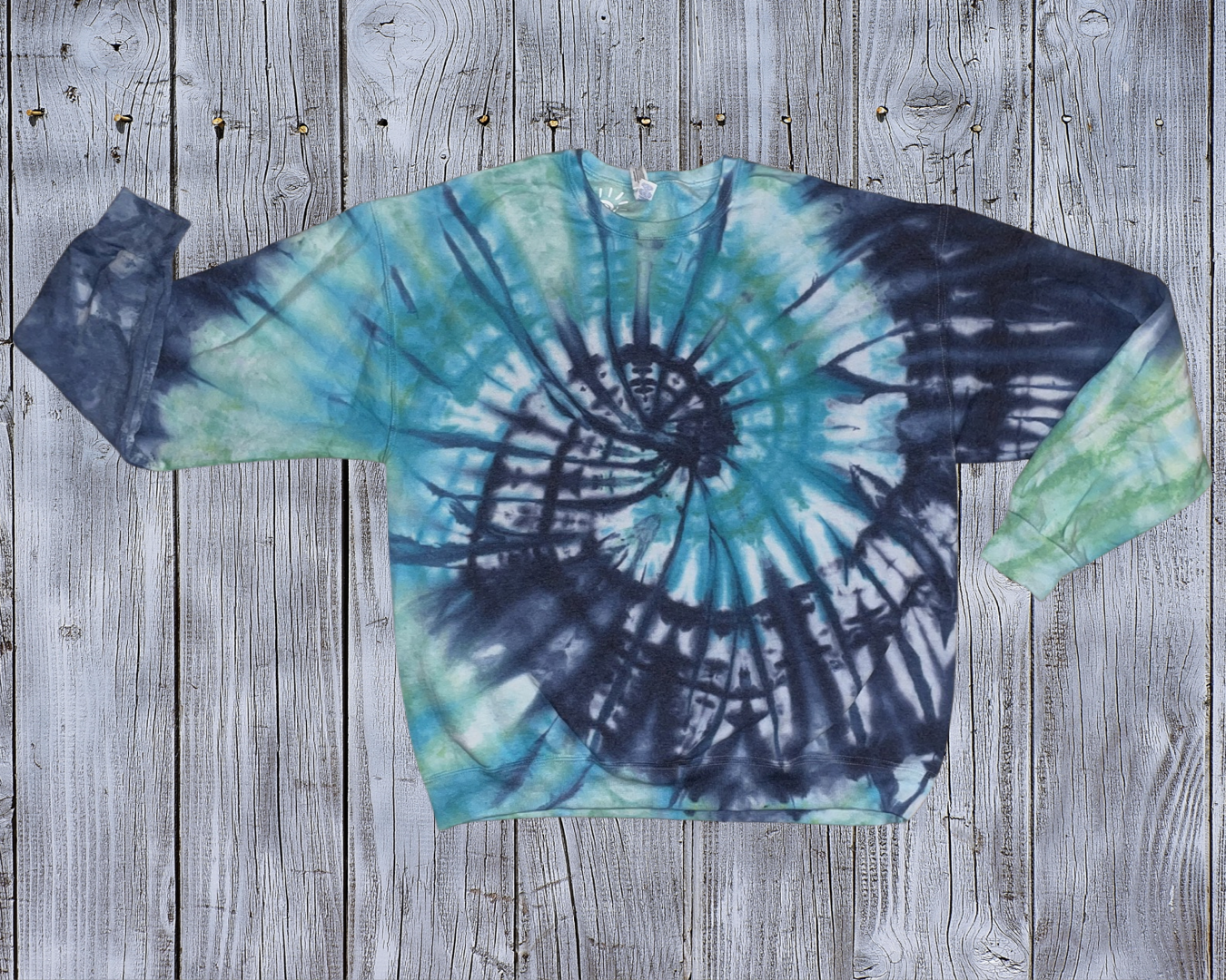 This X-Large Ice Dyed Sweatshirt is made with love by Rainbow Sunshine Dye by Sol! Shop more unique gift ideas today with Spots Initiatives, the best way to support creators.