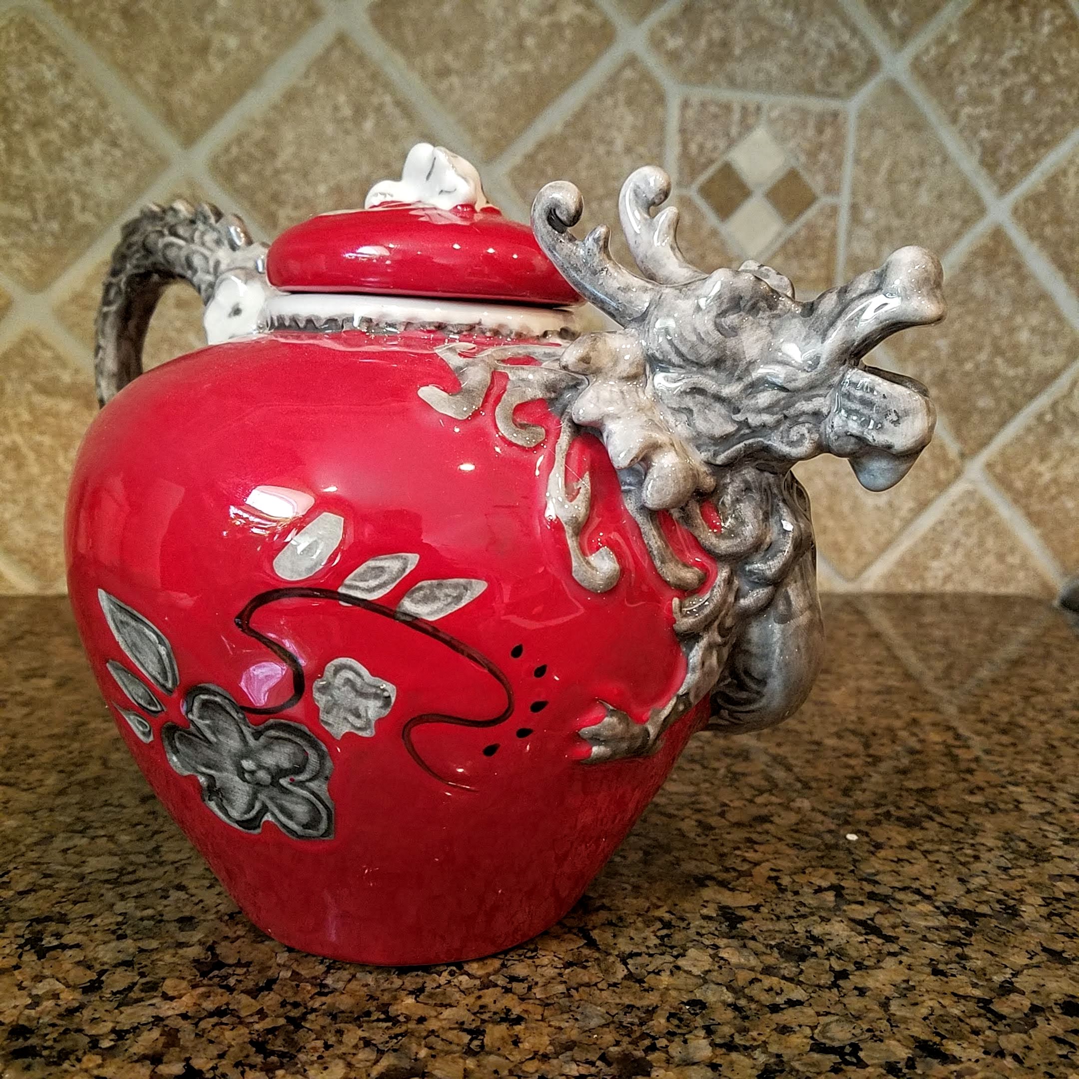 This Red Dragon Teapot Decorative Collectible Kitchen Décor Heather Goldminc Blue Sky is made with love by Premier Homegoods! Shop more unique gift ideas today with Spots Initiatives, the best way to support creators.