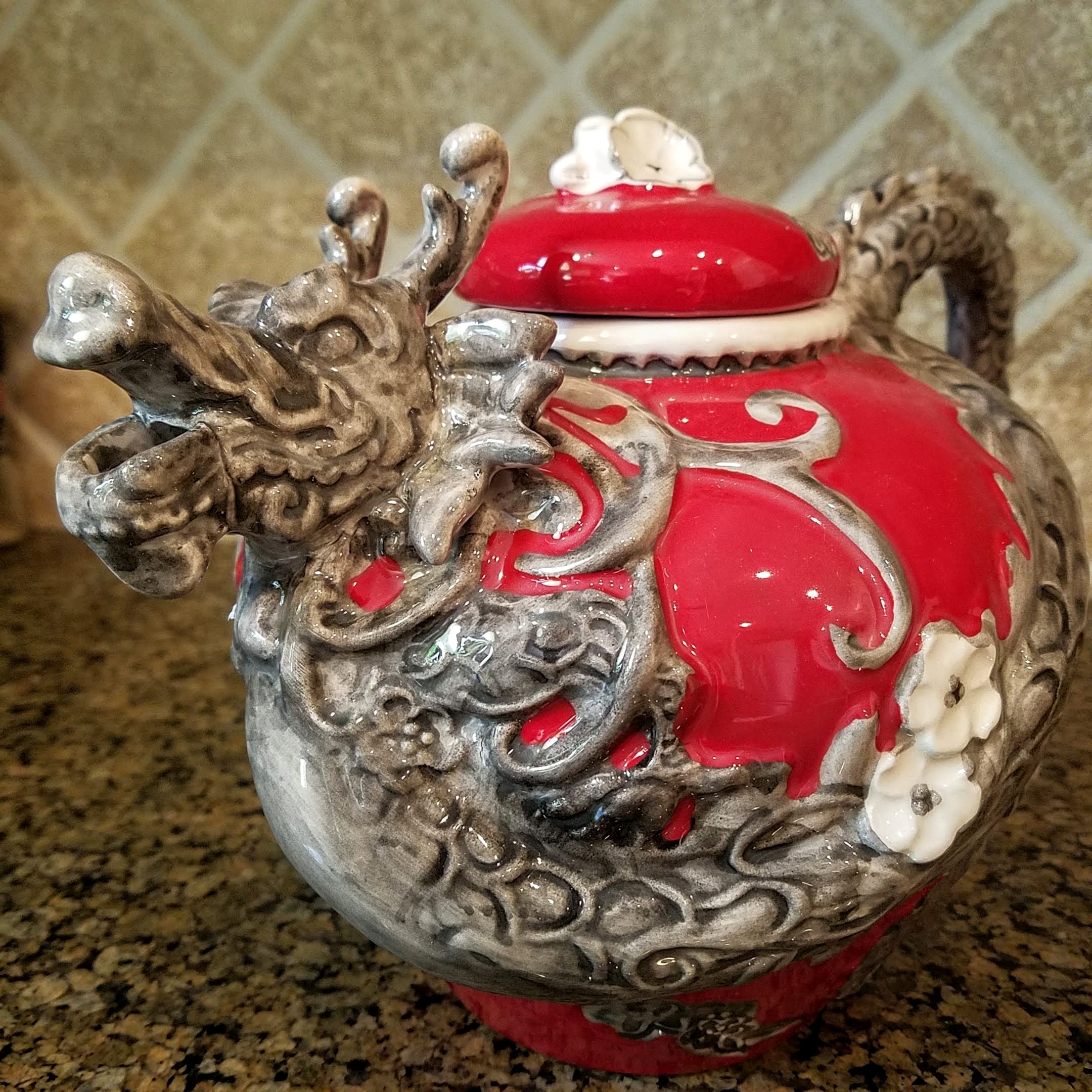 This Red Dragon Teapot Decorative Collectible Kitchen Décor Heather Goldminc Blue Sky is made with love by Premier Homegoods! Shop more unique gift ideas today with Spots Initiatives, the best way to support creators.