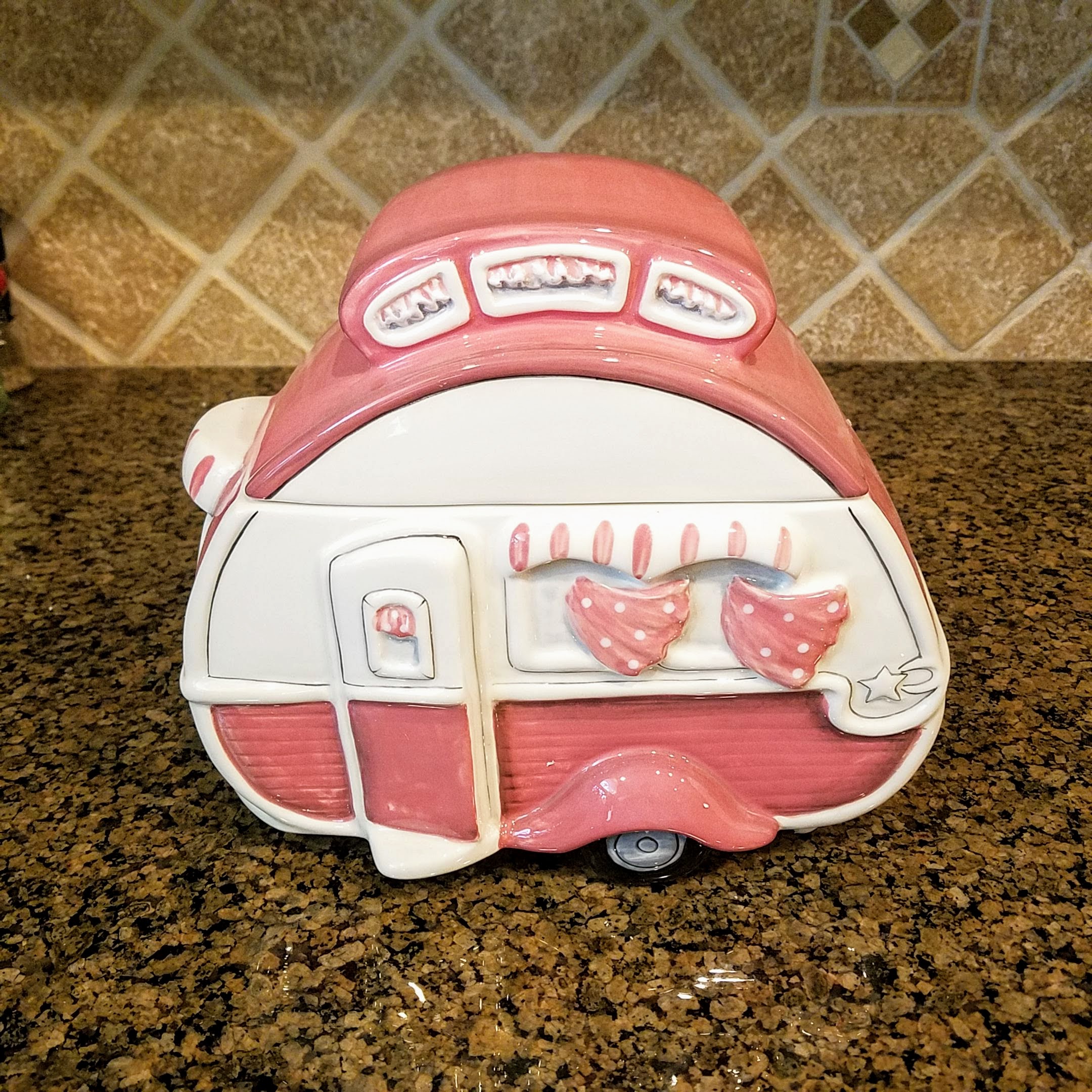 This Retro Camper Cookie Jar Pink Ceramic Blue Sky Heather Goldminc Kitchen Decor is made with love by Premier Homegoods! Shop more unique gift ideas today with Spots Initiatives, the best way to support creators.