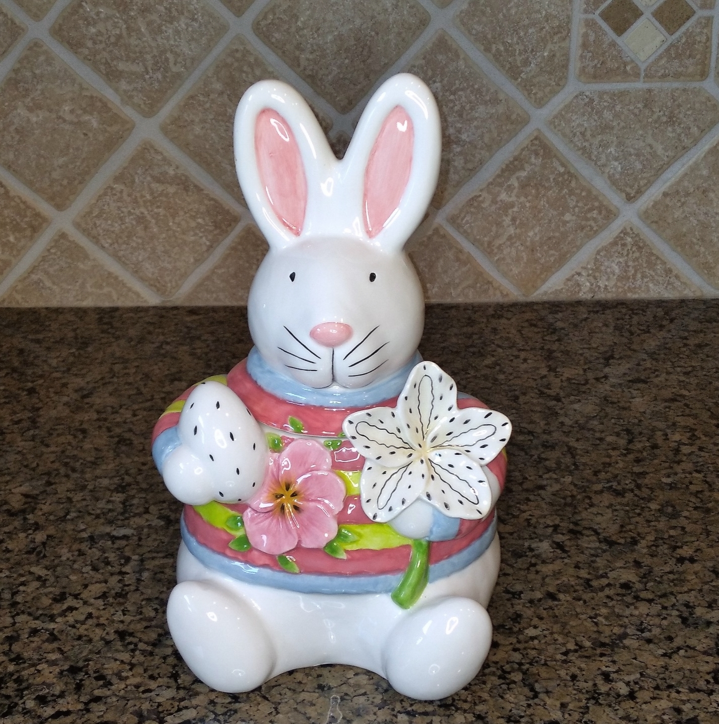 This White Floral Bunny Treat Jar Decorative Easter Home Décor Blue Sky Clayworks is made with love by Premier Homegoods! Shop more unique gift ideas today with Spots Initiatives, the best way to support creators.