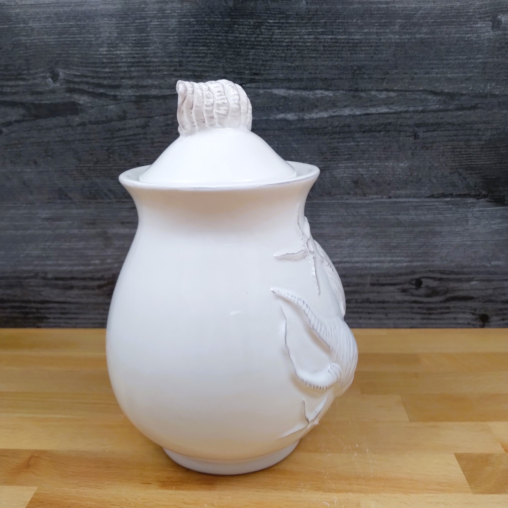 This Laguna Coastal Shell Canister 8" White Decorative Sea Life Jug by Blue Sky is made with love by Premier Homegoods! Shop more unique gift ideas today with Spots Initiatives, the best way to support creators.
