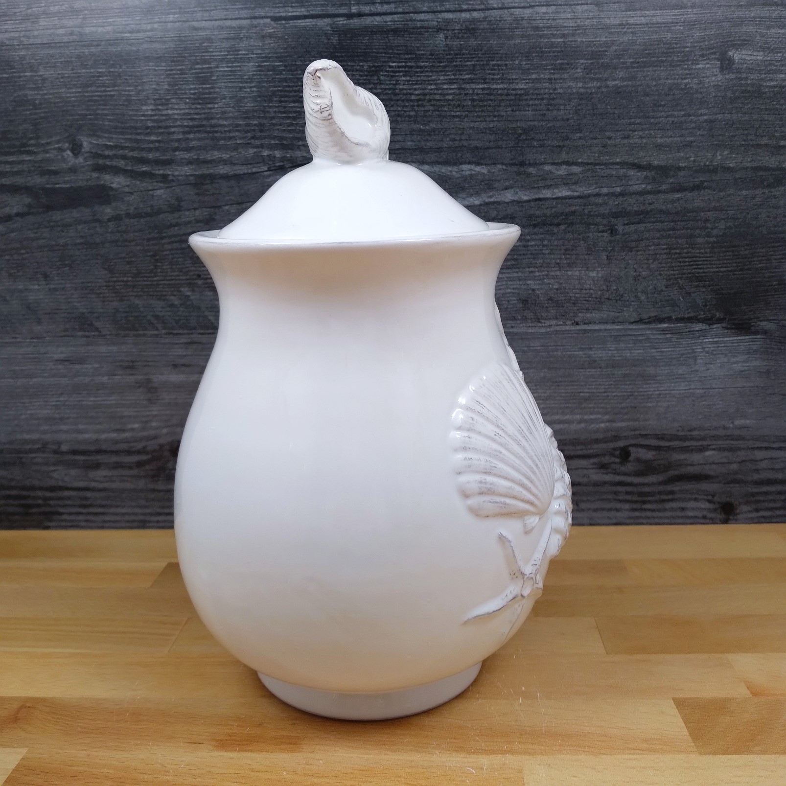 This Laguna Coastal Shell Canister 9" White Decorative Sea Life Jug by Blue Sky is made with love by Premier Homegoods! Shop more unique gift ideas today with Spots Initiatives, the best way to support creators.