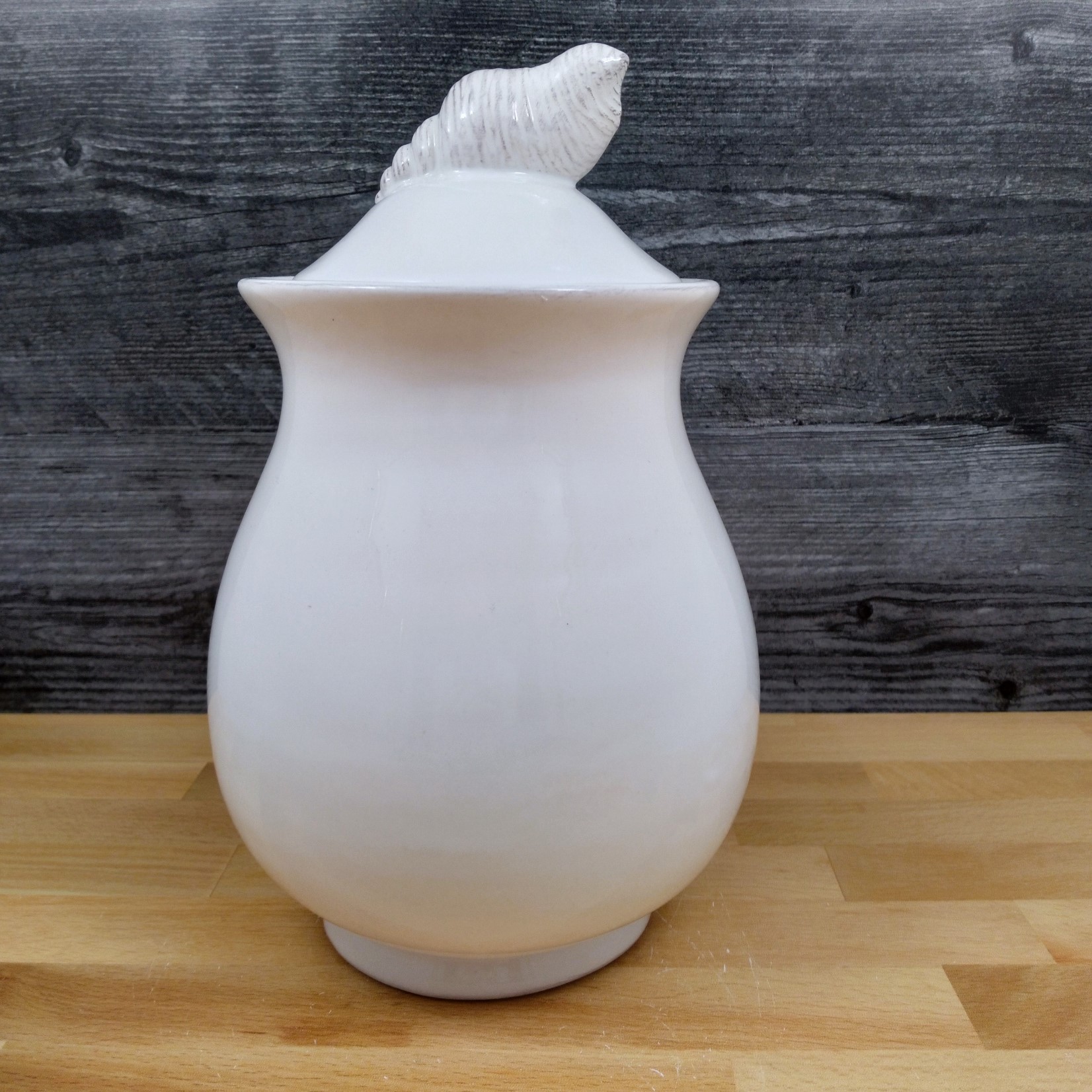 This Laguna Coastal Shell Canister 9" White Decorative Sea Life Jug by Blue Sky is made with love by Premier Homegoods! Shop more unique gift ideas today with Spots Initiatives, the best way to support creators.