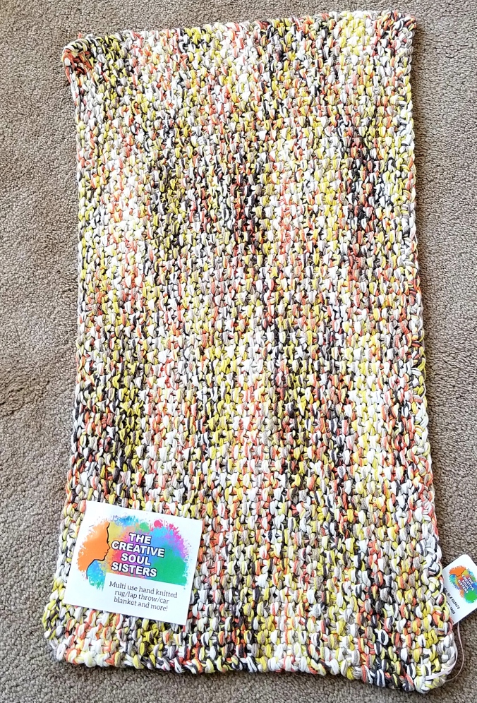 This Hand Knit Rug / Throw/ Blanket Oatmeal, Papaya, Yellow, Gray  30" x 17" is made with love by The Creative Soul Sisters! Shop more unique gift ideas today with Spots Initiatives, the best way to support creators.