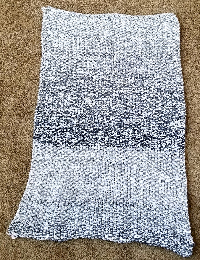 This Hand Knit Rug / Throw/ Blanket Shades of Gray and White  35.5" x 26" is made with love by The Creative Soul Sisters! Shop more unique gift ideas today with Spots Initiatives, the best way to support creators.