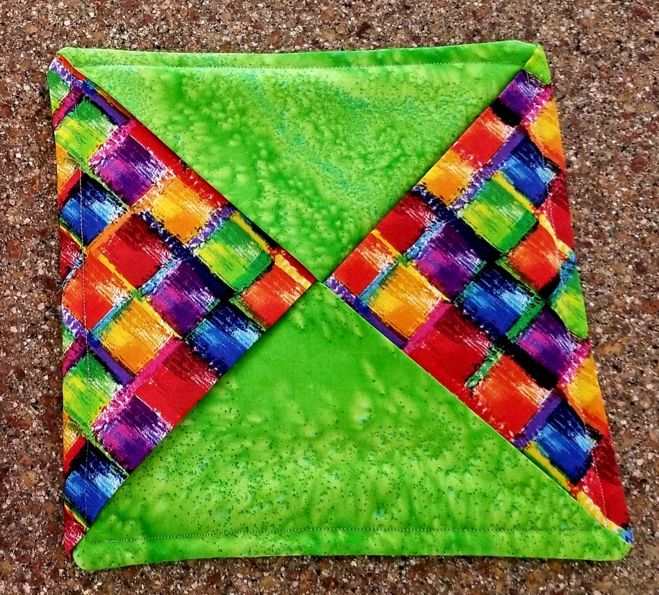 This Hot Pad / Trivet / Potholder - Quilted 9" - Handmade - Modern Brights is made with love by The Creative Soul Sisters! Shop more unique gift ideas today with Spots Initiatives, the best way to support creators.