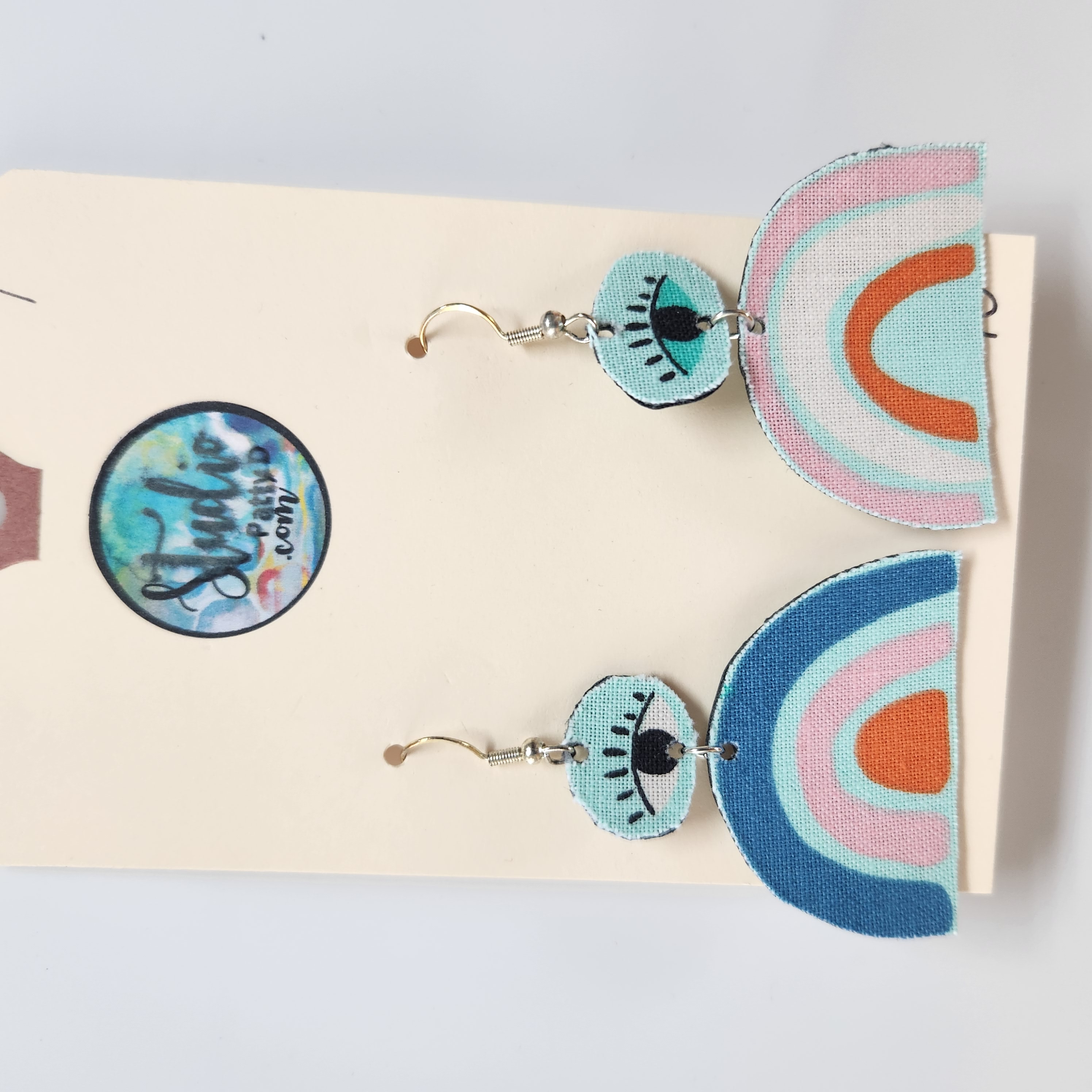 This Fishhook Pierced Earrings - Rainbows have eyes is made with love by Studio Patty D! Shop more unique gift ideas today with Spots Initiatives, the best way to support creators.
