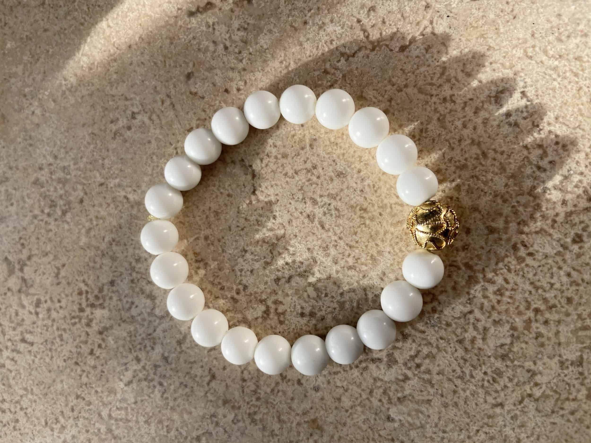 This White and gold bead stretchy bracelet is made with love by Adelu Jewelry! Shop more unique gift ideas today with Spots Initiatives, the best way to support creators.