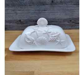This Laguna Coastal White Butter Dish w/Ocean Sea Shells Blue Sky Kitchen Decorative is made with love by Premier Homegoods! Shop more unique gift ideas today with Spots Initiatives, the best way to support creators.