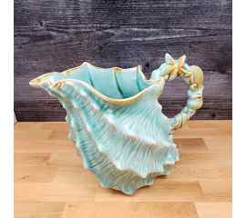 This Shell Figure Pitcher Embossed Decorative Ocean Sea Life by Blue Sky is made with love by Premier Homegoods! Shop more unique gift ideas today with Spots Initiatives, the best way to support creators.