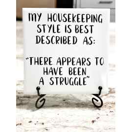 This My Housekeeping Style is Best Described as:  “There appears to have been a struggle’  Ceramic Tile Sign with Easel is made with love by Anything Goes (with grey) Creations! Shop more unique gift ideas today with Spots Initiatives, the best way to support creators.