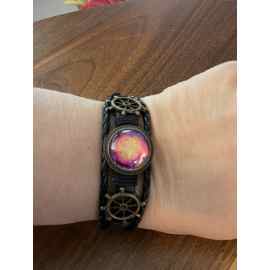This Leather bracelet with adjustable snap and hand painted with alcohol inks red, gold, purple is made with love by Designs by Starla! Shop more unique gift ideas today with Spots Initiatives, the best way to support creators.