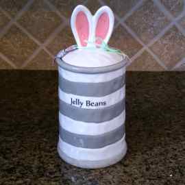 This Bunny Nibbles Cookie Treat Jar Easter Canister Home Décor Blue Sky Clayworks is made with love by Premier Homegoods! Shop more unique gift ideas today with Spots Initiatives, the best way to support creators.