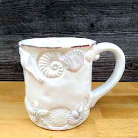 This Sea Shells Laguna Coastal White Coffee Mug Embossed Nautical Tea Cup by Blue Sky is made with love by Premier Homegoods! Shop more unique gift ideas today with Spots Initiatives, the best way to support creators.
