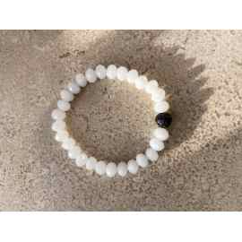 This White Crystal and Lava Bead Stretchy Bracelet is made with love by Adelu Jewelry! Shop more unique gift ideas today with Spots Initiatives, the best way to support creators.
