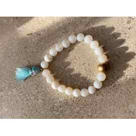 This White Stretchy with Turquoise Tassel Bracelet is made with love by Adelu Jewelry! Shop more unique gift ideas today with Spots Initiatives, the best way to support creators.